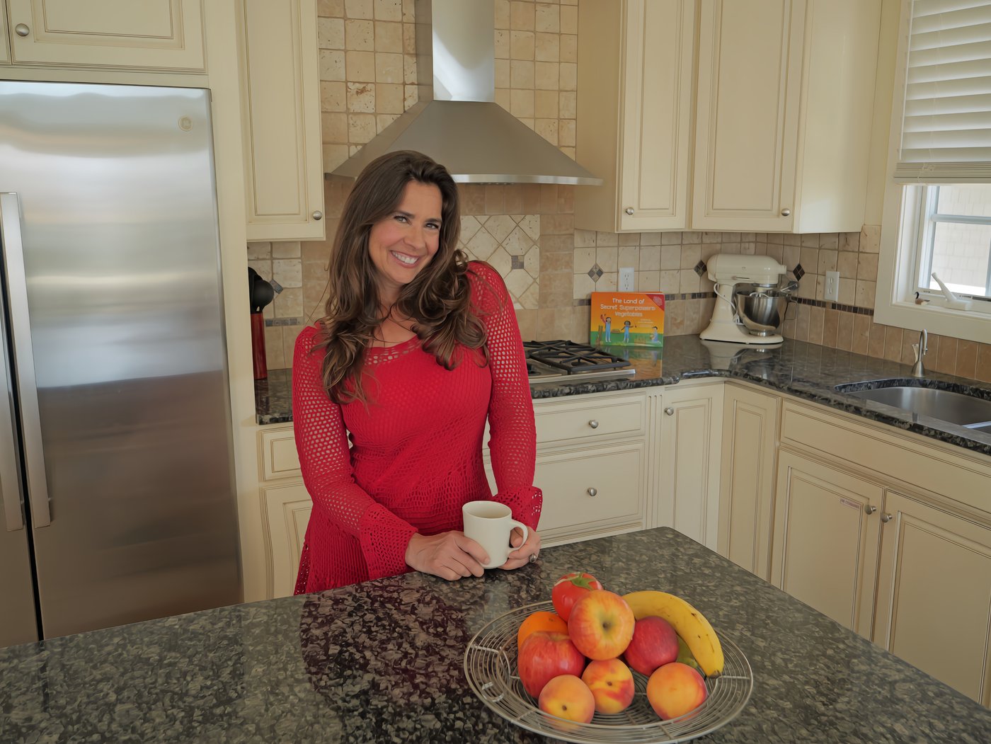 Devin Alexander in her kitchen, coffee mug in hand